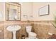 Elegant bathroom with pedestal sink, toilet and tiled floors at 1653 W Zion Pl, Chandler, AZ 85248