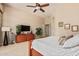 Bright bedroom with large bed, wood dresser and mounted TV at 1653 W Zion Pl, Chandler, AZ 85248