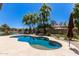 Inviting kidney-shaped pool with a large patio and lake view at 1653 W Zion Pl, Chandler, AZ 85248