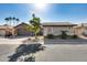 Front view of a single-story home with a stone facade and landscaped yard at 17352 N Rainbow Cir, Surprise, AZ 85374