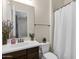 Small bathroom with white toilet and vanity, shower with curtain at 1988 E Blackhawk Dr, Gilbert, AZ 85298