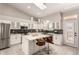 Modern kitchen features white cabinets, a large island, and stainless steel appliances at 20384 N 52Nd Ave, Glendale, AZ 85308