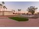 Community putting green with palm trees and landscaping at 205 S Higley Rd # 189, Mesa, AZ 85206