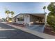 Mobile home featuring a carport and desert landscaping at 205 S Higley Rd # 189, Mesa, AZ 85206