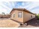 View of the side of the home and desert landscaping of the backyard at 2077 W Tanner Ranch Rd, San Tan Valley, AZ 85144