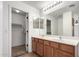 Bright bathroom with a double vanity and a door leading to a walk-in closet at 2077 W Tanner Ranch Rd, San Tan Valley, AZ 85144