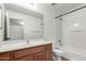 Bathroom with a vanity, mirror, and a shower-tub combo at 2077 W Tanner Ranch Rd, San Tan Valley, AZ 85144