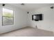 Bedroom featuring carpet, a window, and a mounted television at 2077 W Tanner Ranch Rd, San Tan Valley, AZ 85144