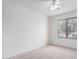 Bright bedroom features neutral carpet, a ceiling fan and natural light from the window at 2077 W Tanner Ranch Rd, San Tan Valley, AZ 85144