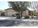 Front view of tan house with mature tree and landscaping at 2077 W Tanner Ranch Rd, San Tan Valley, AZ 85144