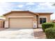 Inviting single-level home with a neutral color palette, a spacious driveway, and a neatly manicured front yard at 2077 W Tanner Ranch Rd, San Tan Valley, AZ 85144