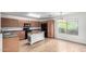 Modern kitchen with wood cabinets, black appliances, an island, and a window overlooking the backyard at 2077 W Tanner Ranch Rd, San Tan Valley, AZ 85144