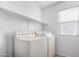 Bright laundry room featuring a utility sink, window, and overhead storage shelf at 2077 W Tanner Ranch Rd, San Tan Valley, AZ 85144