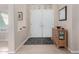 Bright entryway with double doors, wood cabinet, and geometric rug at 21410 N 157Th Ave, Sun City West, AZ 85375