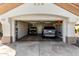 Two-car garage with golf cart and extra storage space at 21410 N 157Th Ave, Sun City West, AZ 85375