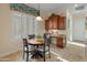 Kitchen breakfast nook with a round table and built-in desk at 26324 W Yukon Ct, Buckeye, AZ 85396