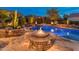 Inviting pool and spa with fire features and night lighting at 26324 W Yukon Ct, Buckeye, AZ 85396