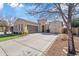 House exterior featuring a large driveway and mature tree at 2867 E Citadel Ct, Gilbert, AZ 85298