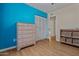 Bedroom with light wood flooring, dresser, and closet at 3001 W Villa Maria Dr, Phoenix, AZ 85053