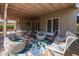 This backyard patio has outdoor seating on a brick surface under a cozy covered patio area at 305 W Lewis Ave, Phoenix, AZ 85003