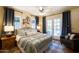 Comfortable bedroom featuring a ceiling fan, a cozy armchair, and elegant French doors to the exterior at 305 W Lewis Ave, Phoenix, AZ 85003