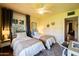 Bright bedroom featuring two beds, a ceiling fan, and a large window at 305 W Lewis Ave, Phoenix, AZ 85003