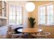 Cozy breakfast nook features a light fixture and built-in seating with a round table at 305 W Lewis Ave, Phoenix, AZ 85003