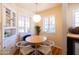 Cozy breakfast nook features a built-in seating area with a table and white chairs at 305 W Lewis Ave, Phoenix, AZ 85003