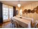 Cozy dining area with a rustic table setting and access to the laundry area through an arched doorway at 305 W Lewis Ave, Phoenix, AZ 85003