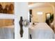 A dining room is seen through a doorway with vintage crystal-like door knob and dining table with a white tablecloth at 305 W Lewis Ave, Phoenix, AZ 85003