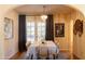 Elegant dining room with a chandelier, patio doors, and stylish decor elements on the walls at 305 W Lewis Ave, Phoenix, AZ 85003