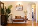 Charming entryway with a wooden bench, decorative pillows, and a view into a bright, tiled bathroom at 305 W Lewis Ave, Phoenix, AZ 85003