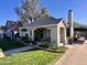 Charming single-story home with a well-manicured lawn and inviting front porch at 305 W Lewis Ave, Phoenix, AZ 85003