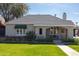 Inviting single-story home with a green awning over the front window and a well-maintained lawn at 305 W Lewis Ave, Phoenix, AZ 85003