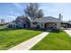 Lovely front yard with a lush green lawn and mature tree providing shade to the home at 305 W Lewis Ave, Phoenix, AZ 85003