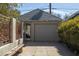 Exterior view of a detached garage with a well-maintained gray door and ample parking space at 305 W Lewis Ave, Phoenix, AZ 85003