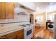 Bright kitchen features an oven, white tiled backsplash and countertops, and light wood cabinets at 305 W Lewis Ave, Phoenix, AZ 85003