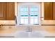 Bright kitchen sink area featuring a white double basin and a window providing natural light at 305 W Lewis Ave, Phoenix, AZ 85003