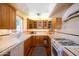 Bright kitchen features a gas oven, tiled backsplash and countertops, and light wood cabinets at 305 W Lewis Ave, Phoenix, AZ 85003