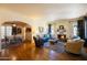 Bright and airy living room with a cozy fireplace and open archway to the dining area at 305 W Lewis Ave, Phoenix, AZ 85003