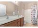 Bathroom with double sinks, shower/tub combo, and colorful shower curtain at 32211 N Lepa Dr, San Tan Valley, AZ 85144