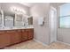 Double vanity bathroom with wood cabinets and tiled floor at 32211 N Lepa Dr, San Tan Valley, AZ 85144