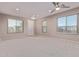 Bright and airy living room with neutral carpeting and large windows at 32211 N Lepa Dr, San Tan Valley, AZ 85144