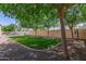 Landscaped backyard with grassy area, mature trees, and a sparkling pool at 3503 E Princeton Ct, Gilbert, AZ 85234