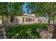 House exterior and backyard with grassy area, mature trees, and a sparkling pool at 3503 E Princeton Ct, Gilbert, AZ 85234