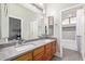 Bathroom with double sinks, wood cabinets, and a bathtub at 3503 E Princeton Ct, Gilbert, AZ 85234