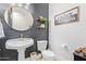 Stylish powder room with pedestal sink, decorative mirror, and shiplap accent wall at 3503 E Princeton Ct, Gilbert, AZ 85234