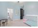 Light blue walls, white crib, small table and chairs at 3503 E Princeton Ct, Gilbert, AZ 85234