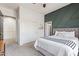 Guest bedroom with a green accent wall and ensuite bath at 3503 E Princeton Ct, Gilbert, AZ 85234