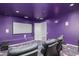 Home theater with purple walls, projector, and screen at 3503 E Princeton Ct, Gilbert, AZ 85234